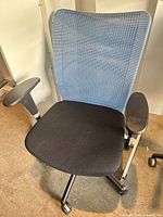 Front three-quarter view of office chair showing mesh back, seat, arms and base