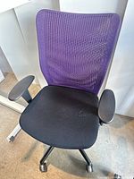 Front view of purple mesh back office chair showing seat, armrests and wheeled base
