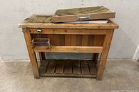 Full view of wooden bar station front showing cooler lid, basket, shelf