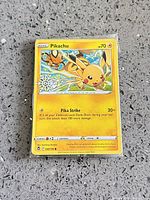 Front view of Pikachu 049/195 card in protective sleeve