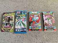 Group shot of all four sealed Pokémon booster packs