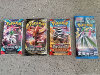 All four sealed Pokémon TCG booster packs side by side