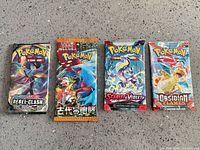 Front view of all four sealed booster packs