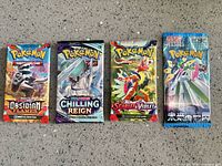 Front view of four sealed Pokémon booster packs