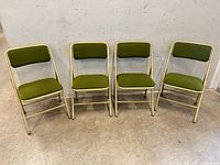 Front view of four matching Singer folding chairs