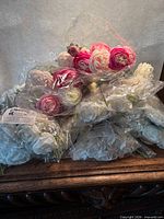 Pile of sealed artificial flower bundles on tabletop