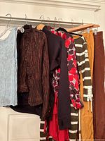 Overview of seven garments hanging on rack