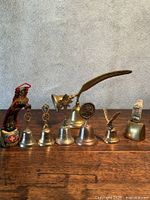 Front view of all eight bells lined up on table