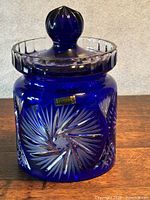 Full view of cobalt blue cut crystal jar with lid showing sticker and patterns
