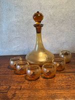 Full view of decanter with stopper and six matching tumblers