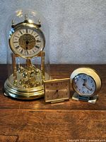 All three clocks side by side showing relative sizes and styles