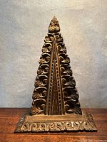 Full front view showing overall triangular carved panel