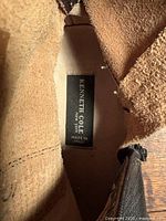 Interior label reading 'Kenneth Cole New York Made in Italy' showing branding and origin