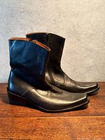 Left side view of both boots showing leather, heel and profile