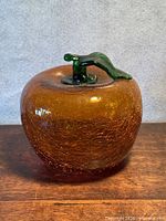 Front view of amber crackle glass apple