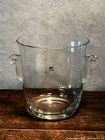 Front view of clear glass ice bucket showing shape and handles