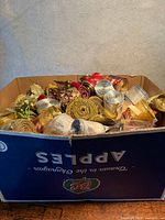 Cardboard box filled with assorted rolled ribbons