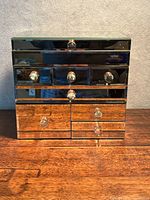 Front view showing mirrored surface and drawer arrangement