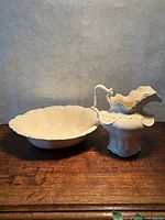 Pitcher and basin side by side on table