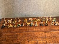 Row of Wade miniature figurines on wooden surface