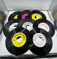 Nine records spread out showing various labels including Peter Pan, Book and Record, Hot Line, Hugh...