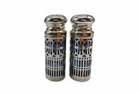 Front view of both shakers showing pierced silver casing and cobalt blue glass liners