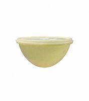 Side view of pastel yellow Tupperware bowl with lid attached
