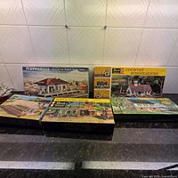 Five Plasticville boxed kits displayed upright on counter