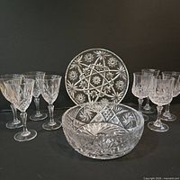 Group view of serving bowl, serving plate and eight wine glasses