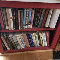 Two shelves filled with hardcover books of varied subjects