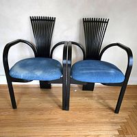 Front view of both Totem chairs showing black frames and blue seats