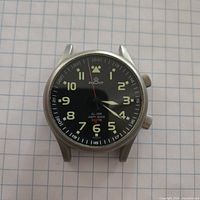 Front view of Poljot alarm watch head on grid paper