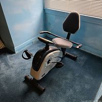 Full view of recumbent bike showing seat, backrest, frame and console