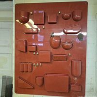 Front view of red Uten.Silo showing all molded compartments and hooks