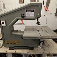 Front view of Rockford bandsaw showing table, blade, housing, power switch