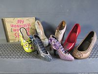 All seven decorative shoe figurines with book