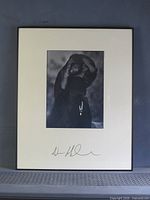 Framed black & white portrait photograph showing full view with mat and frame