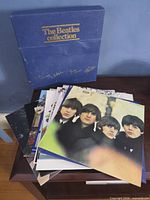 Blue Beatles Collection box with stack of album jackets, two titles visible