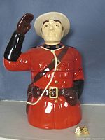 Front view of complete Mountie cookie jar with pins