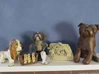 Front view of all six dog figurines on shelf
