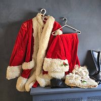 Full Santa suit pieces displayed: coat, pants, hat, wig, beard, black boot covers