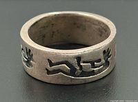 Side view of sterling band showing cut-out figures