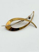 Front view of Birks modernist gold brooch