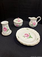 Group shot showing all visible pieces: bud vase with underplate, lidded sugar bowl, creamer, dessert plate(s)