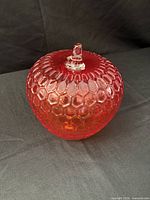 Front view of honeycomb-pattern orange glass apple