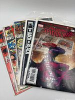 Stack of five Spider-Man comics in sleeves