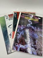 Front view showing four bagged comic issues