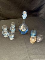 all items grouped: decanter with stopper, nine glasses
