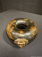 Full view of round box showing dragon decoration and central opening