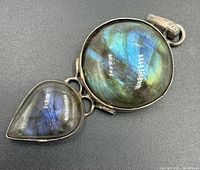 Front view showing round and pear cabochons in silver setting